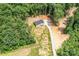 Distant aerial view of a one story home surrounded by lush forestry at 122 River Ridge Ln, Hickory, NC 28601