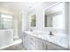 Bright bathroom boasts double sinks, marble countertops, and a tiled walk-in shower at 122 River Ridge Ln, Hickory, NC 28601