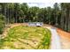 Charming one story home features a gray exterior, new landscaping, and a gravel driveway at 122 River Ridge Ln, Hickory, NC 28601