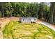 Exterior shot of a charming home nestled in a wooded area, showcasing its gray siding and inviting entrance at 122 River Ridge Ln, Hickory, NC 28601