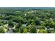Aerial view of the property features green trees, a house and neighborhood at 12712 Hollyhock Ln, Huntersville, NC 28078