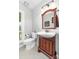 Bathroom featuring a wood vanity with elegant mirror, ceramic sink, toilet, and tiled floors at 12712 Hollyhock Ln, Huntersville, NC 28078