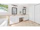 Well-lit bathroom with double sinks, vanity, a soaking tub, and tile flooring at 12712 Hollyhock Ln, Huntersville, NC 28078