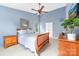Comfortable bedroom with soft blue walls, a wooden bed, and a bright, airy feel at 12712 Hollyhock Ln, Huntersville, NC 28078