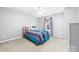 Inviting bedroom featuring a bed with bright blue accents and soft neutral walls at 12712 Hollyhock Ln, Huntersville, NC 28078
