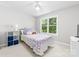 Bright bedroom featuring a ceiling fan, and a window with natural light at 12712 Hollyhock Ln, Huntersville, NC 28078