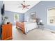 Cozy bedroom featuring a wooden bed frame, neutral walls, and ample natural light at 12712 Hollyhock Ln, Huntersville, NC 28078