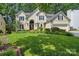 Charming two-story home with a well-manicured lawn and lush landscaping at 12712 Hollyhock Ln, Huntersville, NC 28078