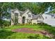 Traditional home featuring a lush front yard and mature trees at 12712 Hollyhock Ln, Huntersville, NC 28078