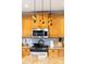 Close-up of a gourmet kitchen showcasing custom cabinetry, granite countertops, pendant lighting, and stainless steel appliances at 12712 Hollyhock Ln, Huntersville, NC 28078