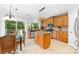 Bright kitchen featuring stainless steel appliances, granite countertops, a central island, and a breakfast nook with deck access at 12712 Hollyhock Ln, Huntersville, NC 28078