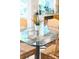 Bright kitchen breakfast nook with rattan chairs around glass table and a lush plant in a white pot at 12712 Hollyhock Ln, Huntersville, NC 28078