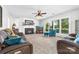 Comfortable living room features plush seating, fireplace, large windows, and neutral carpeting at 12712 Hollyhock Ln, Huntersville, NC 28078