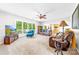 Bright living room with large windows, plush seating, and an inviting, open floor plan at 12712 Hollyhock Ln, Huntersville, NC 28078
