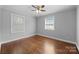 Well-lit bedroom with hardwood floors, neutral walls, and dual windows at 1319 Mt Gallant Rd, Rock Hill, SC 29732