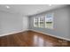 Serene bedroom with hardwood floors and three large windows offering ample natural light at 1319 Mt Gallant Rd, Rock Hill, SC 29732