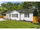 Classic home with a dark roof, white siding, black shutters, and lush green lawn at 1319 Mt Gallant Rd, Rock Hill, SC 29732