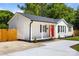 Charming white house with a bright red door and a well-manicured lawn at 1319 Mt Gallant Rd, Rock Hill, SC 29732
