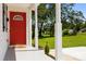 Inviting front porch with white columns and a red door, overlooking a lush green lawn at 1319 Mt Gallant Rd, Rock Hill, SC 29732