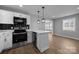 Bright kitchen with stainless steel appliances, white cabinets, and a window overlooking the backyard at 1319 Mt Gallant Rd, Rock Hill, SC 29732