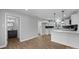 Open-concept kitchen with white cabinets, a breakfast bar, and view of the nearby bathroom at 1319 Mt Gallant Rd, Rock Hill, SC 29732