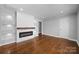 Bright living room with hardwood floors, a modern electric fireplace, and custom built-in shelving at 1319 Mt Gallant Rd, Rock Hill, SC 29732