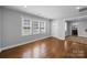 Bright living room with hardwood floors, large windows, and an open doorway to the kitchen and bathroom at 1319 Mt Gallant Rd, Rock Hill, SC 29732