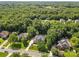 Aerial view of the neighborhood showcasing the house, trees, and surrounding community at 1336 Dobson Dr, Waxhaw, NC 28173