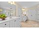 Bright bathroom with a double vanity, white cabinets, and tiled floors at 1336 Dobson Dr, Waxhaw, NC 28173