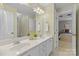 Bright bathroom with a double vanity, white cabinets and a view of the bedroom at 1336 Dobson Dr, Waxhaw, NC 28173