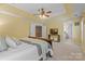 A bright bedroom features a ceiling fan, neutral walls, and a view of an ensuite bathroom at 1336 Dobson Dr, Waxhaw, NC 28173