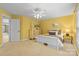 A bright bedroom featuring yellow walls, carpeted floors, and a white bed at 1336 Dobson Dr, Waxhaw, NC 28173