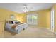Well-lit bedroom featuring yellow walls, carpeted floors, and a large window at 1336 Dobson Dr, Waxhaw, NC 28173