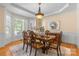 Bright dining room with a chandelier, shutters, area rug and a wooden dining set at 1336 Dobson Dr, Waxhaw, NC 28173