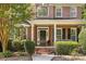Charming front porch with brick accents, trimmed bushes, and a well-manicured garden bed at 1336 Dobson Dr, Waxhaw, NC 28173