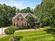 Beautiful brick house with manicured lawn, mature trees, and a well-maintained landscape in a suburban setting at 1336 Dobson Dr, Waxhaw, NC 28173