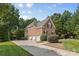 A three car garage with a basketball hoop and an extra long driveway provides plenty of space for vehicles and play at 1336 Dobson Dr, Waxhaw, NC 28173