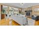 Open-concept living room with stone fireplace, hardwood floors, and abundant natural light at 1336 Dobson Dr, Waxhaw, NC 28173