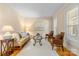 Cozy living room with hardwood floors, area rug, neutral paint and shuttered windows at 1336 Dobson Dr, Waxhaw, NC 28173