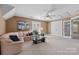 Large living room features a ceiling fan, neutral colors and access to the office at 1336 Dobson Dr, Waxhaw, NC 28173
