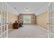 Home office with neutral color paint, natural light, french doors and a ceiling fan at 1336 Dobson Dr, Waxhaw, NC 28173