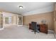 Spacious home office with neutral colors, a ceiling fan, french doors and a wood desk at 1336 Dobson Dr, Waxhaw, NC 28173