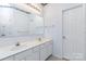 Bathroom with double vanity and a large mirror, plus a bathroom door at 137 Citation Dr, Mooresville, NC 28117