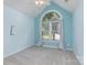 Bright bedroom features neutral carpet, vaulted ceiling, and arched window at 137 Citation Dr, Mooresville, NC 28117