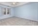 Large main bedroom featuring tray ceiling, carpeting, and bright window at 137 Citation Dr, Mooresville, NC 28117