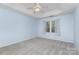 Bright bedroom with tray ceiling, carpet, and natural light from the window at 137 Citation Dr, Mooresville, NC 28117