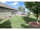 Beautiful backyard featuring a lush green lawn, mature trees, and an inviting patio area at 15018 Marymont Ave, Huntersville, NC 28078