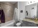 Tiled bathroom features vanity with granite counters and tub with shower at 15018 Marymont Ave, Huntersville, NC 28078