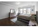 Serene bedroom with hardwood floors, neutral decor, and natural light at 15018 Marymont Ave, Huntersville, NC 28078