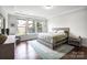 Bright bedroom with hardwood floors, tray ceiling, and large windows with backyard view at 15018 Marymont Ave, Huntersville, NC 28078